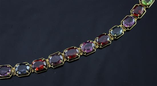 A gold and multi coloured gem bracelet, 6.75in.